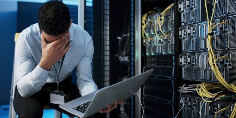 Frustrated,Man,,Mistake,Or,Stress,With,Laptop,In,Server,Room